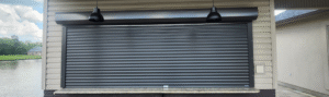 Electric hurricane shutter with remote control on window in Lafayette, LA.