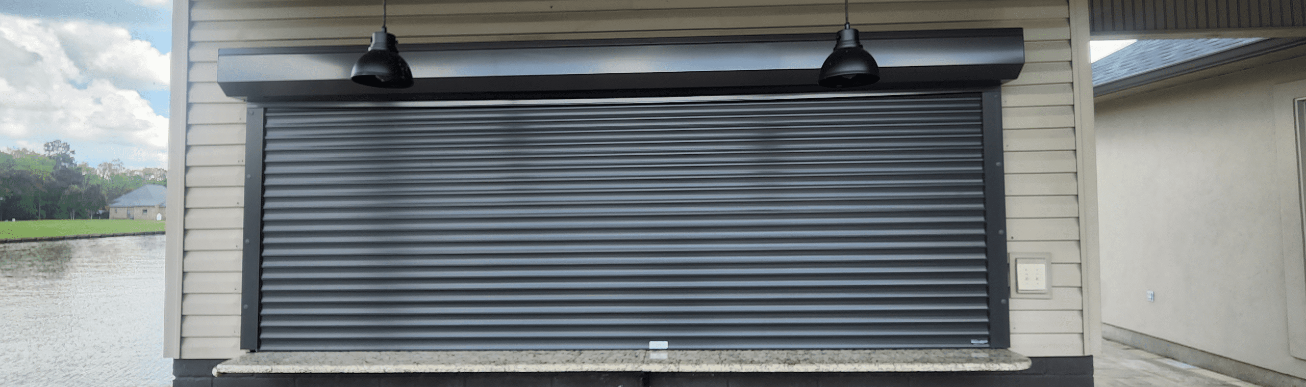 Electric hurricane shutter with remote control on window in Lafayette, LA.